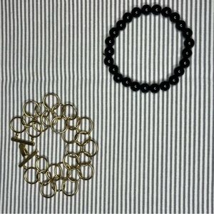 black beaded bracelet and gold rings bracelet